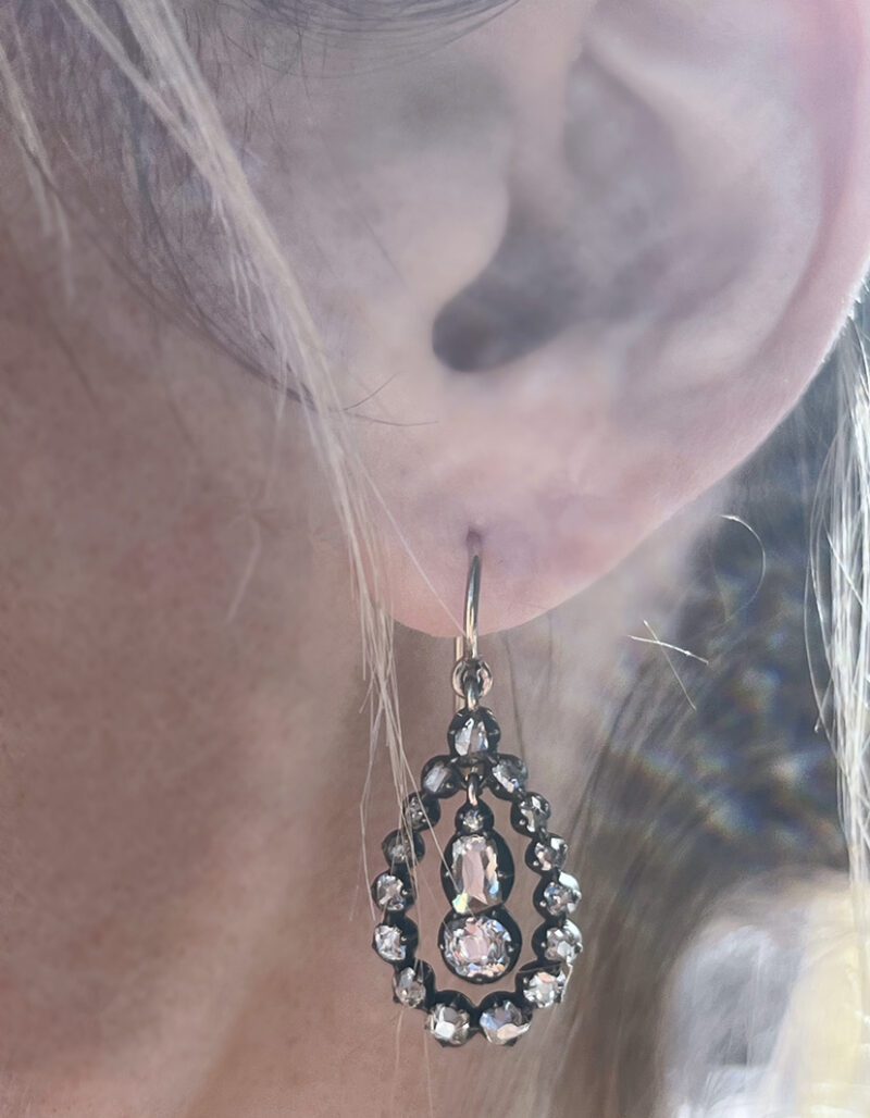 Earring with intricate design on ear.