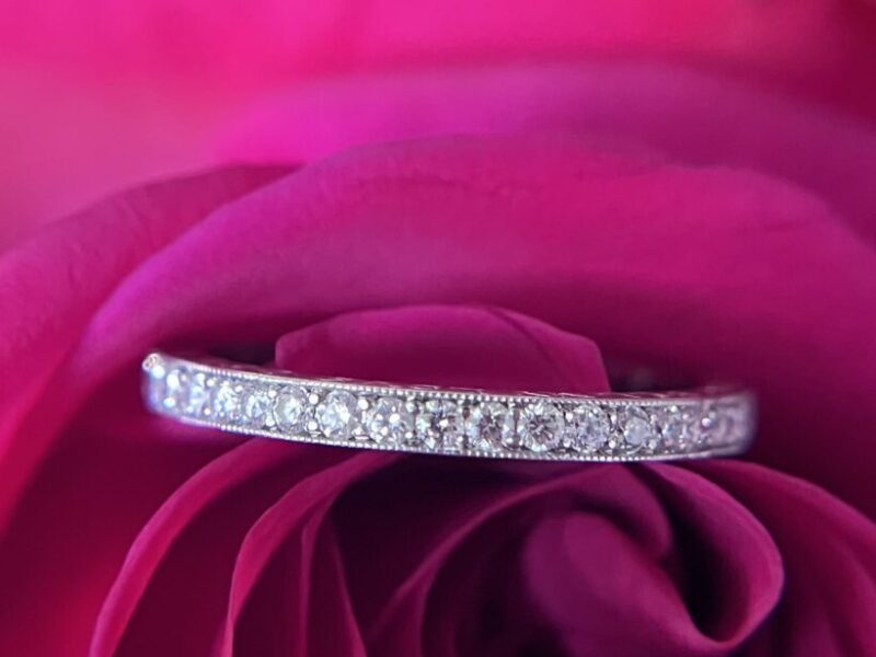 Diamond ring on vibrant pink rose petals.