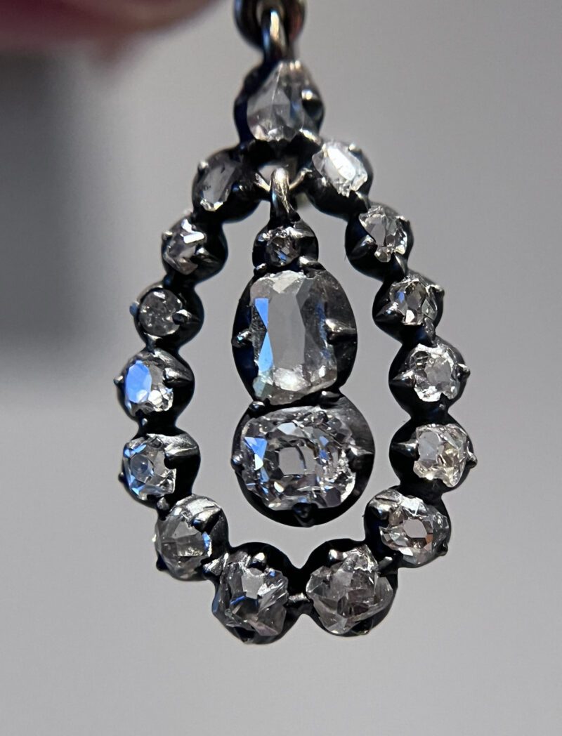 Ornate teardrop-shaped diamond pendant jewelry.
