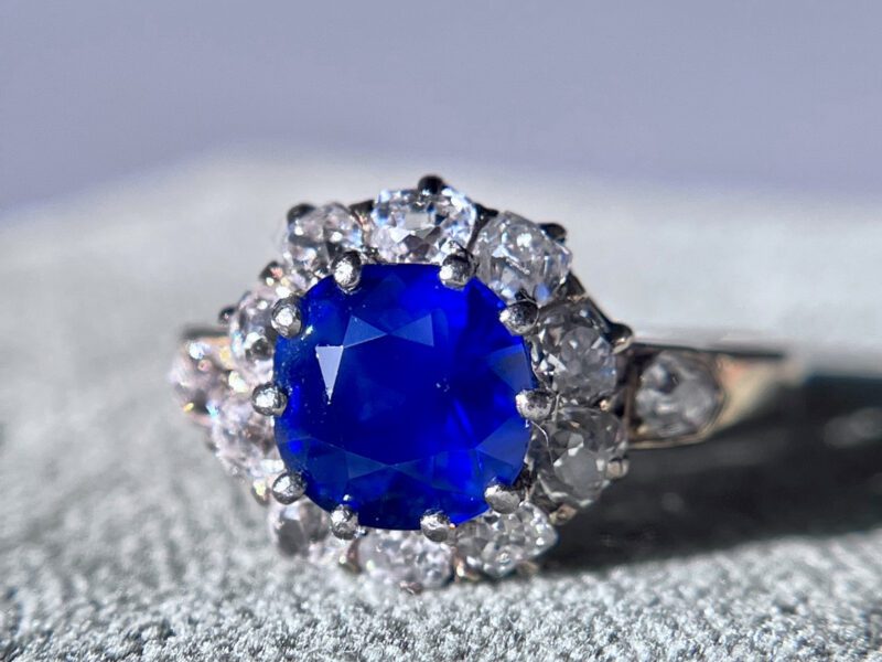 Blue gemstone ring with diamond accents.