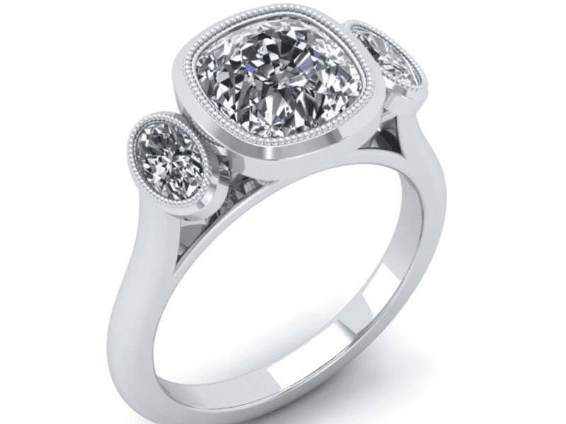 A white gold ring with three diamonds on it.