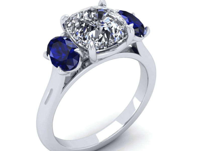 Silver ring with diamond and blue sapphires.