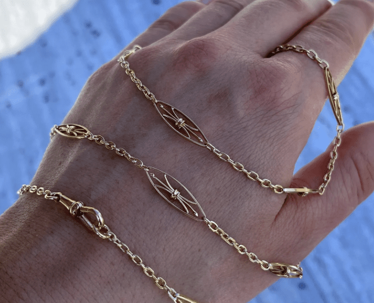 Gold bracelet wrapped around a hand.