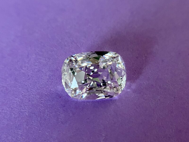 Cushion-cut diamond on purple background.