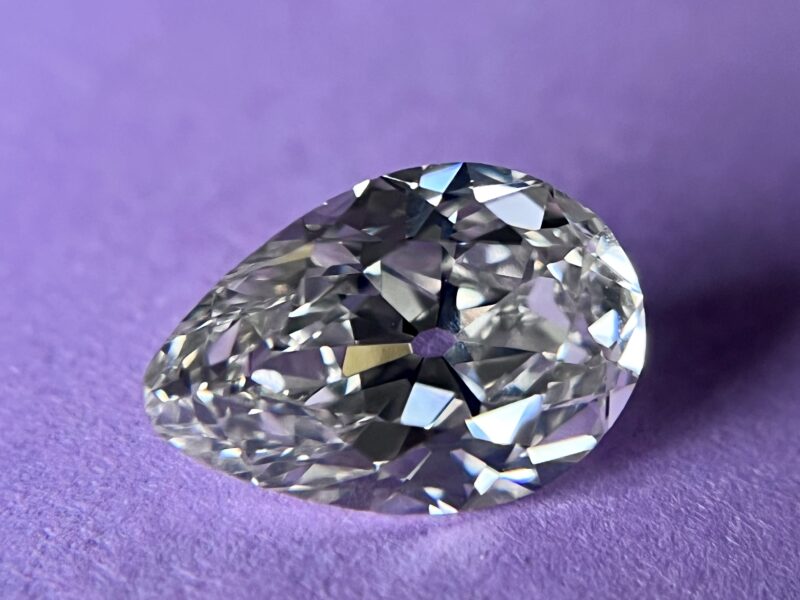 Pear-shaped diamond on purple background.