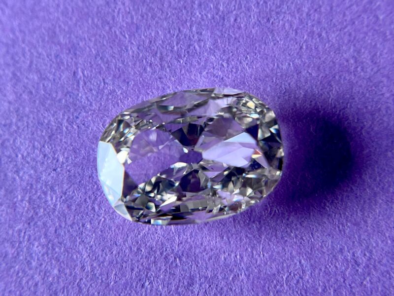 Oval diamond on a purple background.